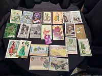 Table layout showing about 20 assorted antique postcards