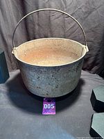 overall view of cast iron pot showing bail handle and interior