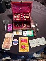Overview of jewelry box and assorted items on table