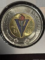 Reverse side showing coloured torch V design, dates 1945-2020, Victory legend