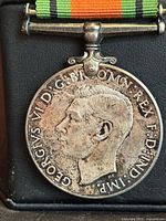 Obverse view of medal showing King George VI profile and ribbon bar