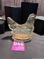 Full view of clear glass hen-on-nest dish with base