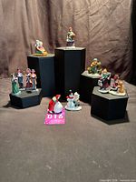 All figurines grouped on black risers
