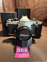 Front view of Nikon FE with 50mm lens and cap