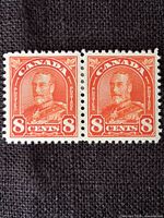 Front view of the pair of 8c red-orange King George V stamps