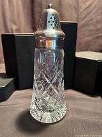 Full view of sugar shaker showing entire form and lid