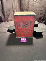 Front view of vintage red coffee tin showing overall form and wear