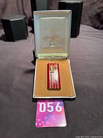 Lighter seated in original open presentation box on black surface