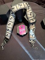 Full view of Bobby Lee Mickey Mouse camera neck strap showing pattern and hardware