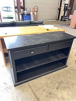 Front view showing drawer, open shelves and overall style