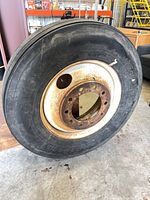 Full view of mounted tire and rim standing upright