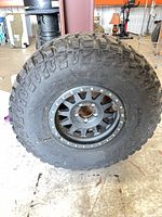 Full view of mounted tire and wheel assembly showing tread depth, wheel style and overall condition