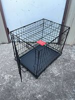 Crate angled view showing open front door, plastic tray inserted