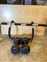 Full view of pull-up bar and both dumbbells