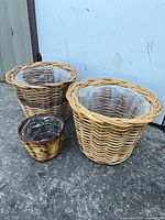All three wicker planters side by side, showing size comparison and liners
