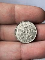 Reverse of 1930 Canada 5-cent coin showing denomination and date