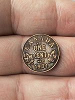Reverse of 1934 Canada one cent coin displaying denomination, maple leaves and date