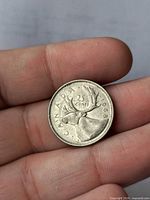 Reverse of 1968 Canadian silver quarter showing caribou design