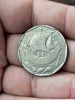 Reverse showing caravel ship and fish