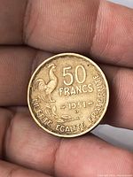 Reverse of coin showing 50 FRANCS, rooster, date 1951