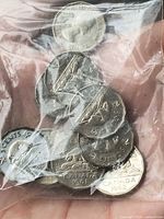 Bag of Canadian 5 cent coins showing beaver reverse, visible dates 1961, 1962