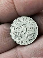 Reverse side showing CANADA FIVE CENTS 1929 with maple leaves