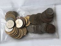 Bag of mixed coins laid flat showing quantity and variety