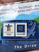 Front view of sealed lapel pin showing logos and design