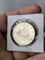 Reverse of 1968 Canadian dollar showing Voyageur design in holder