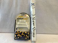 Full lot showing spikes, tees pack and Super Stroke grip