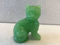 Front view of translucent green jade glass cat figurine