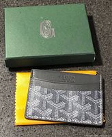 Front view of Goyard card holder with box beneath