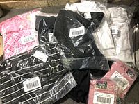 Group shot of sealed Penningtons garments showing colours and barcode labels