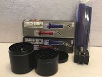 Overall lot showing boxed choppers, black grinders, purple grinder in bag, small black shredder block
