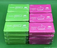 Stack of 24 shrink-wrapped boxes, green Crocodile and pink Rabbit Lapin variants visible