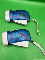 Top view of both 3Tech flashlights showing transparent blue bodies and white crank handles