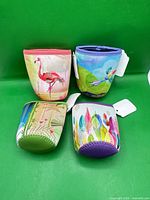 Group shot of four colorful neoprene can coolers