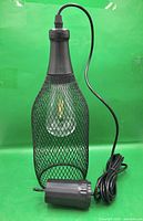 Pendant light outside box showing mesh shade, bulb, cord, battery pack