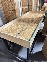 overall view of rectangular wood-top work table on black frame