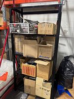 Full view of black metal shelving unit with boxes (contents not included)