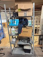 Front view of grey steel shelving showing five tiers and dimensions context