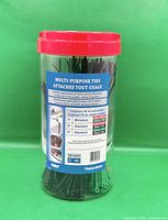 Full view of sealed clear container showing assorted coloured cable ties