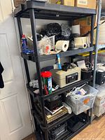 Black five-tier plastic shelving unit with contents shown for scale; contents excluded