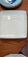 white square dinner plate with grey wave lines