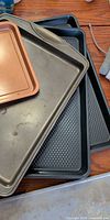 Stacked baking sheets showing variety of finishes and textures