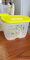 Tupperware produce keeper with lime-green lid and printed panels