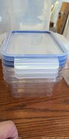 Stack of four rectangular containers with lids