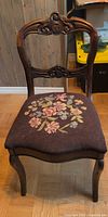 Full view of antique side chair showing seat upholstery and overall form