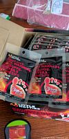 Open box showing multiple packets of Little Hotties adhesive toe warmers