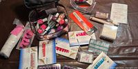 Overview of lot showing cosmetic bag with nail polishes, nail strip sets, press-on nails, mirror, cotton swabs and other accessories